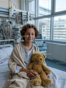 Child in Hospital Bed Holding Teddy Bear in Bright Medical Setting