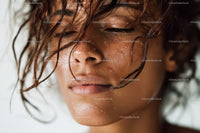 Close-Up of a Smiling Woman with Wet Curly Hair and Dewy Skin