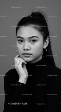 Elegant Black and White Portrait of a Youthful Woman with Hoop Earrings