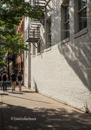 City Sidewalk with Pedestrians and Tree Shadows