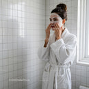 Woman Applying Face Mask in Bathroom for Skincare Routine