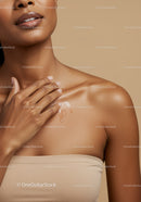 Close-Up of a Woman Applying Moisturizer on Her Shoulder for Skin Care