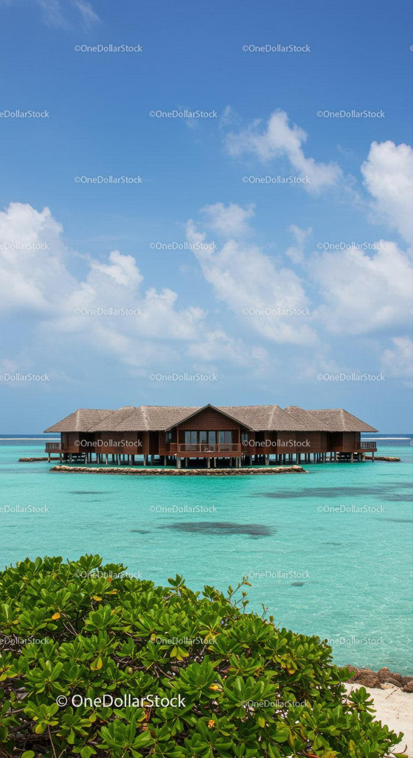 Overwater Bungalow in Turquoise Ocean with Clear Sky and Beach