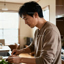 Man focused on preparing fresh salad in home kitchen