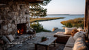Rustic Lakeside Outdoor Lounge with Fireplace and Scenic Water View