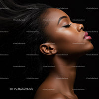 Profile of a serene woman with flowing hair against black