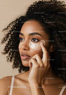 Young Woman Applying Facial Mask for Smooth Glowing Skin