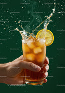 Refreshing iced tea with lemon splash on green background