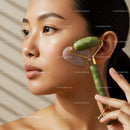 Close-up of Young Asian Woman Using Jade Roller for Facial Massage