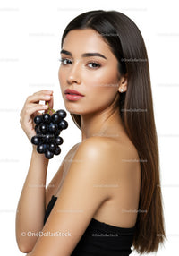 Elegant Woman Holding Black Grapes with Smooth Skin and Long Hair