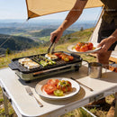 Grilling fresh vegetables and cheese outdoors in mountains