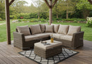 Cozy Outdoor Wicker Sectional Sofa in Lush Garden Setting
