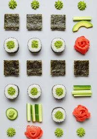 Minimalist sushi and fresh vegetable arrangement on white