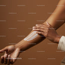 Close-up of a Woman Applying Sunscreen Lotion on Her Arm