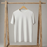 Minimalist white t-shirt hanging on wooden rack