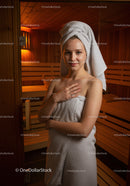 Young Woman Relaxing in Sauna with Towel Wrapped Hair
