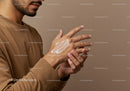 Man Applying Moisturizing Lotion to His Hands for Skin Care Routine