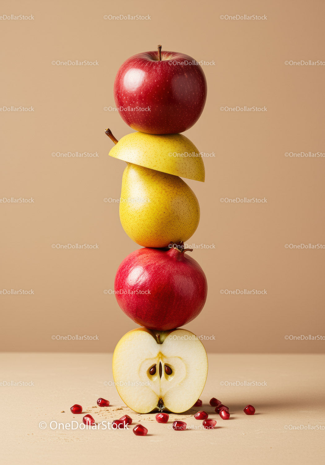 Stacked fresh fruits with pomegranate seeds on beige