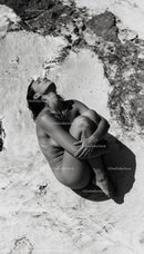 Serene woman embracing solitude in sunlit natural setting