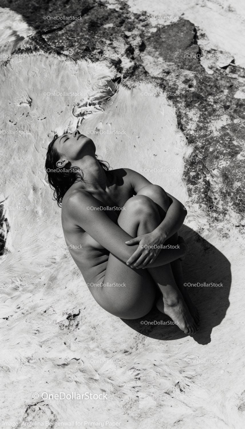 Serene woman embracing solitude in sunlit natural setting