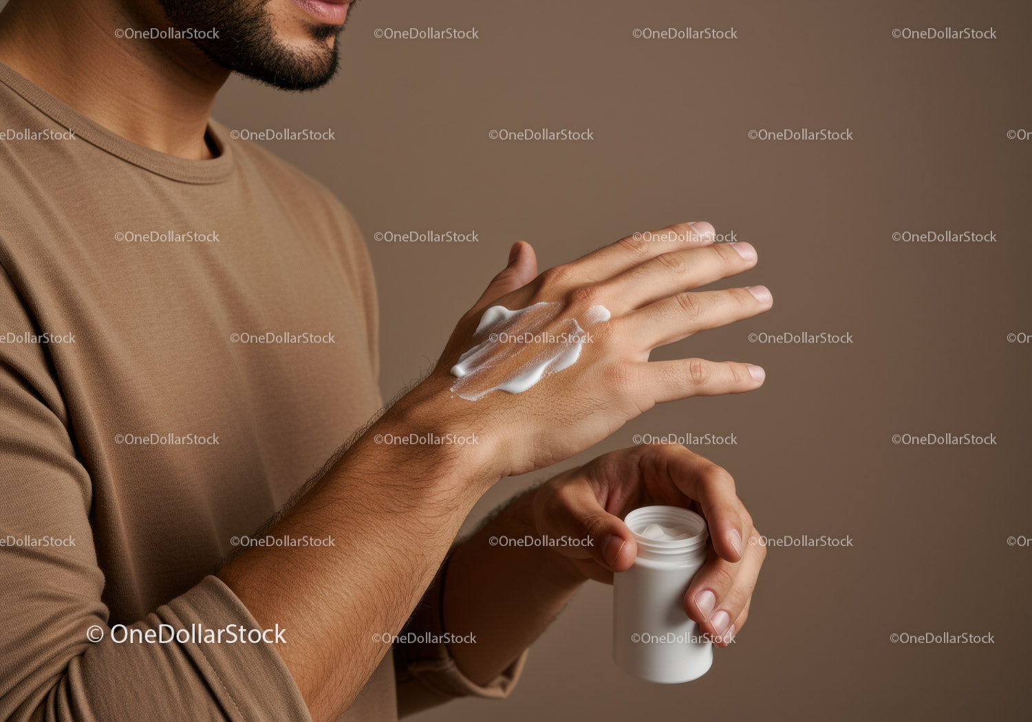 Close-up of Man Applying Lotion on Hands with Cream Jar
