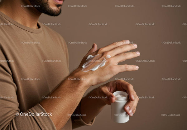 Close-up of Man Applying Lotion on Hands with Cream Jar
