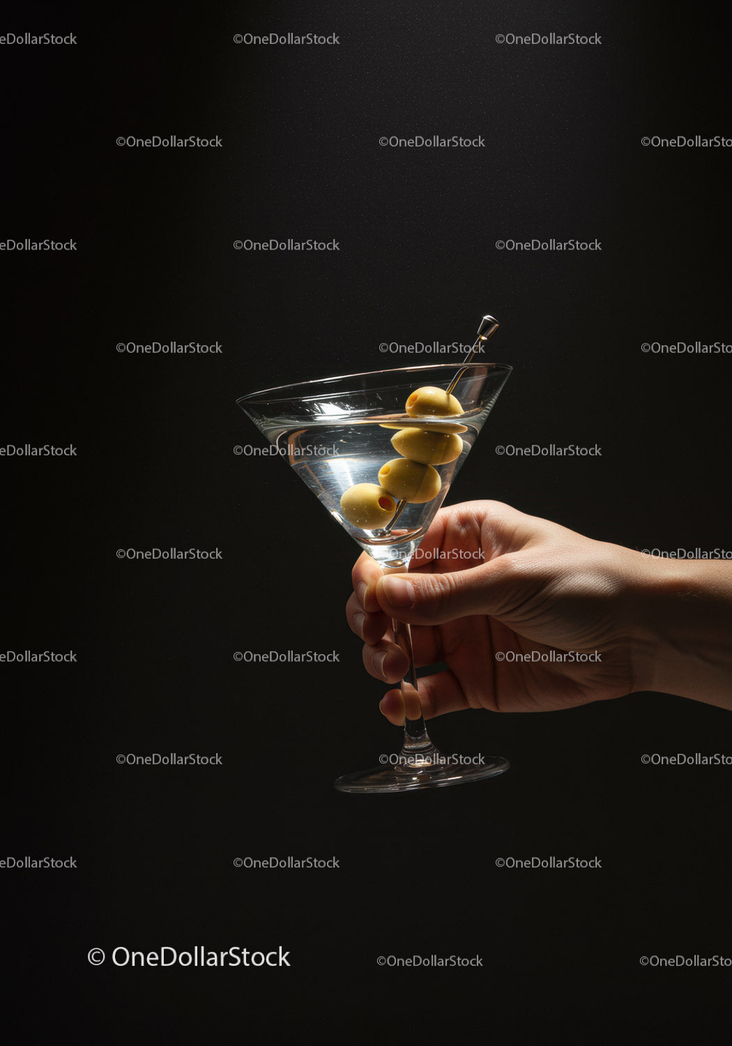 Hand Holding Martini Glass with Olive Garnish