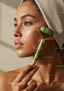Beauty Woman Receiving Facial Massage with Jade Roller for Glowing Skin