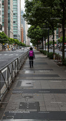City Street Scene with Tall Buildings and Pedestrian Woman