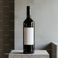 Elegant wine bottle with blank label on concrete surface