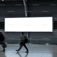 People walking past a large blank city billboard