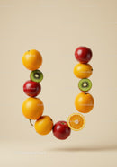 Fresh fruits arranged in a vibrant U shape on beige