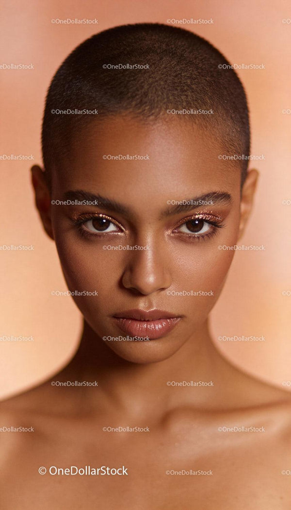 Close-up portrait of confident woman with glowing skin