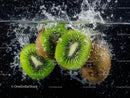Vivid Green Kiwi Slices Splashing into Water