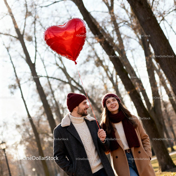 Couple enjoying winter walk with heart-shaped balloon
