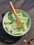 Green Handmade Soap Bars with Wooden Whisk in Bowl