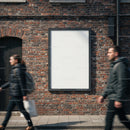 Blank Urban Billboard on Brick Wall with Pedestrians Passing