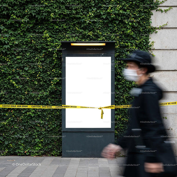Urban blank billboard with caution tape on green wall JPG Mockup Image