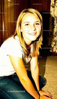 Smiling young woman casually sitting indoors at home