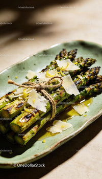 Grilled asparagus tied with string and topped with cheese