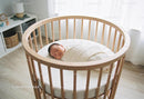 Peaceful newborn wrapped warmly in modern crib