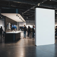 Visitors exploring technology displays in modern showroom