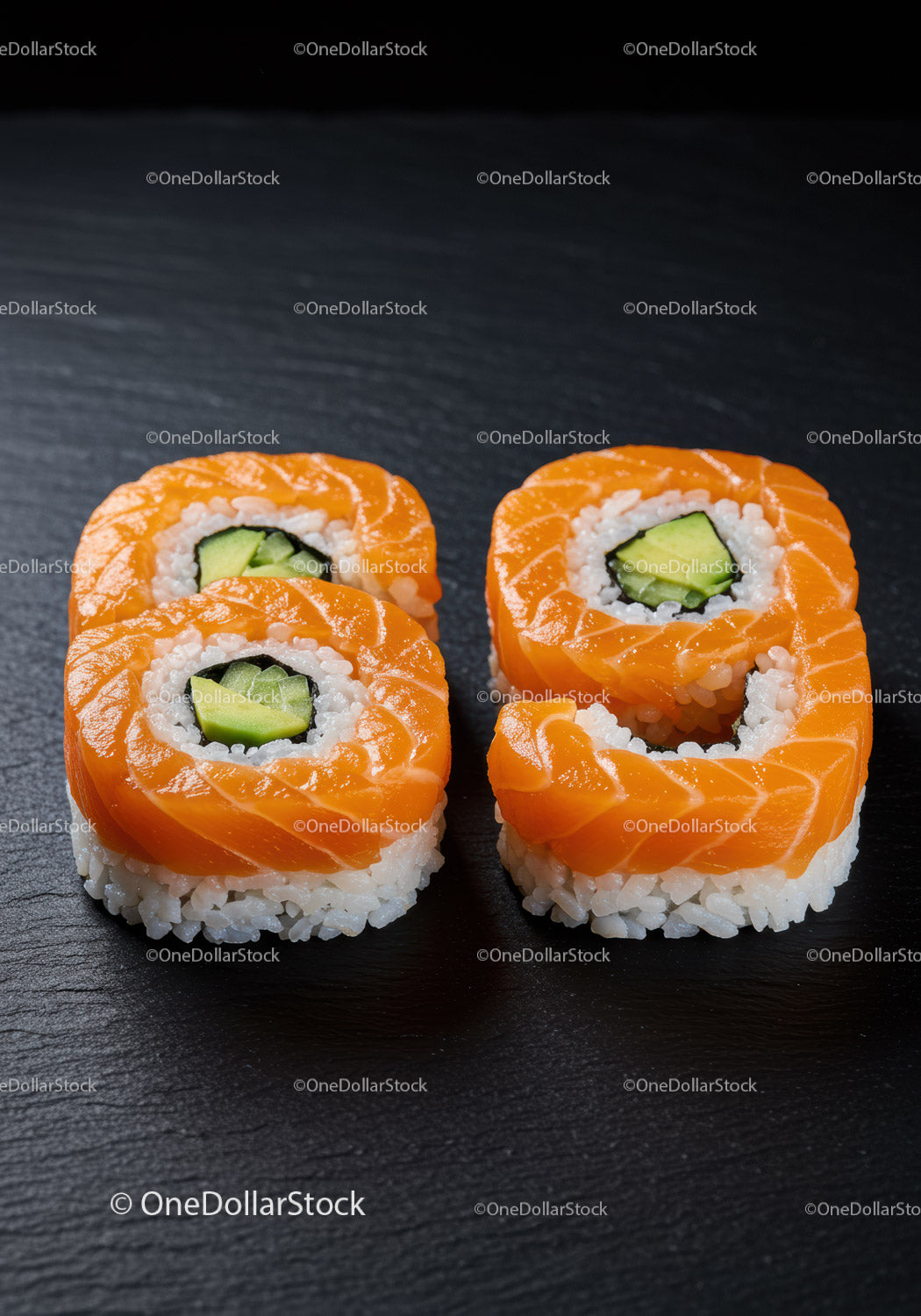 Fresh Salmon Sushi Rolls with Avocado on Black Plate