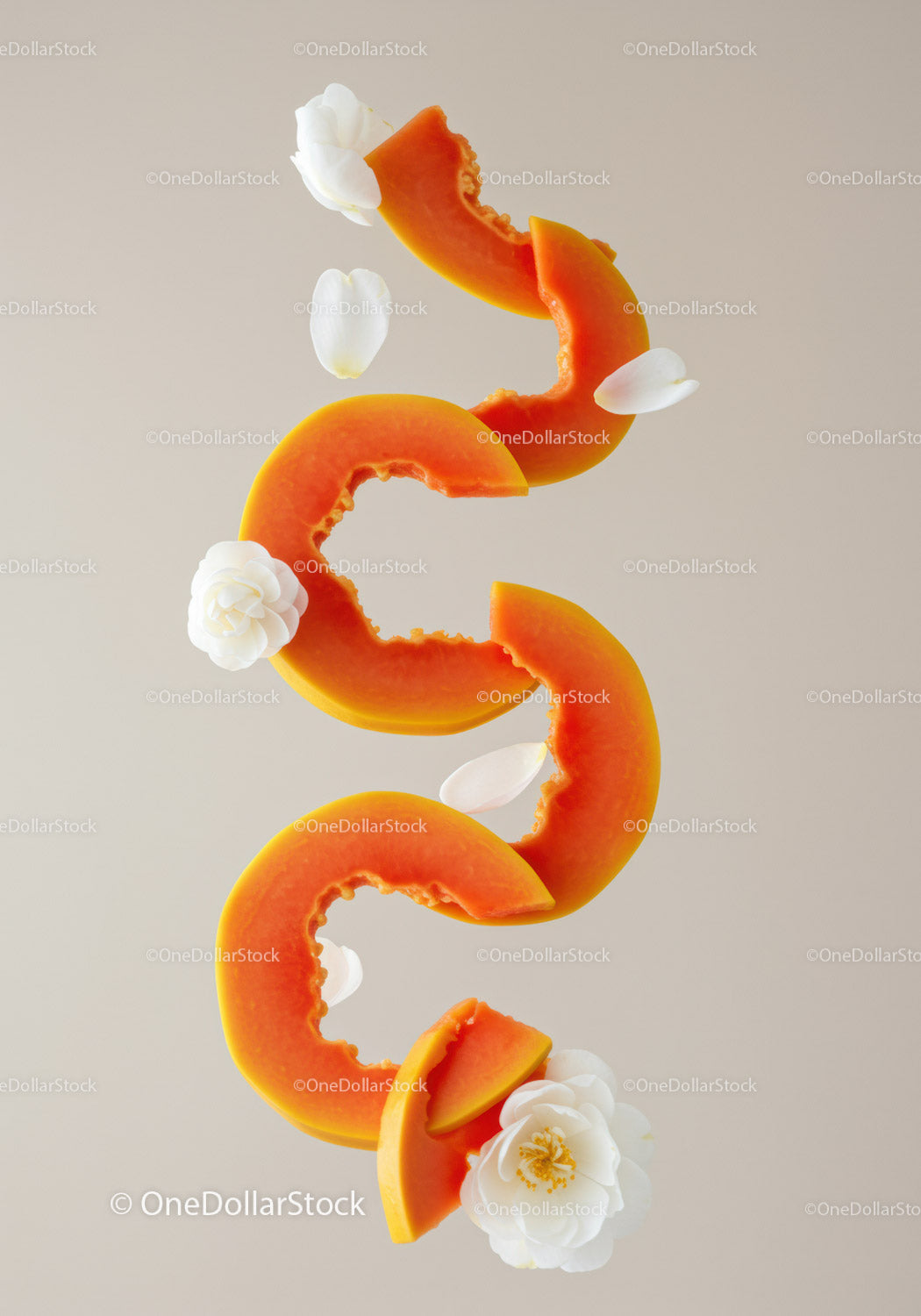 Fresh papaya slices with white flower petals arrangement