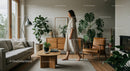 Elegant Woman Walking in a Modern Living Room with Plants