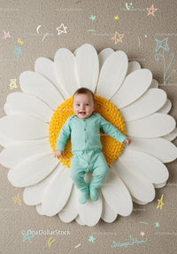 Happy baby lying on giant daisy flower prop