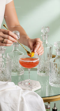 Elegant Woman Preparing a Red Cocktail in Beautiful Glassware