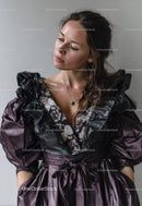 Elegant Woman in Black and Purple Ruffled Dress with Modern Style