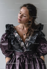 Elegant Woman in Black and Purple Ruffled Dress with Modern Style