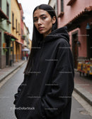Fashionable Woman Wearing Black Hoodie in Urban City Street